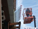 Started constructing the parapet along the high roof at the South Elevation.jpg